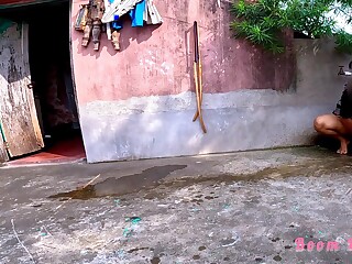 An Indian lady is taking a dump on the street, uninhibited.